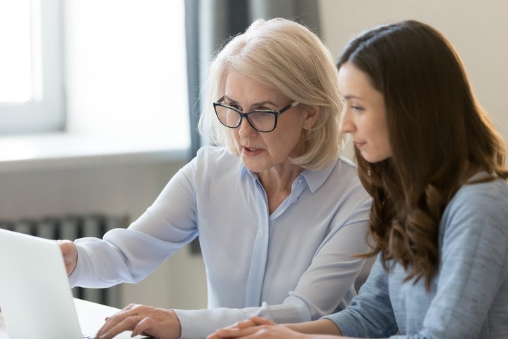 Image of older woman mentoring young woman