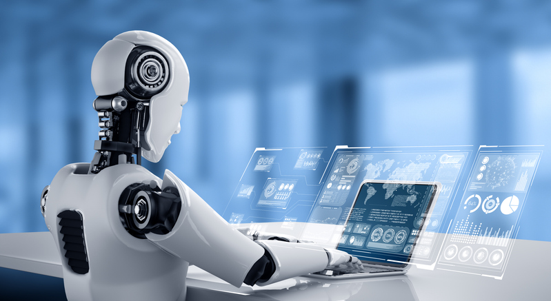 Image of robot working at laptop